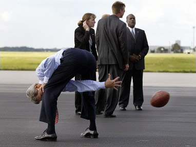John Kerry playing football. Poorly.