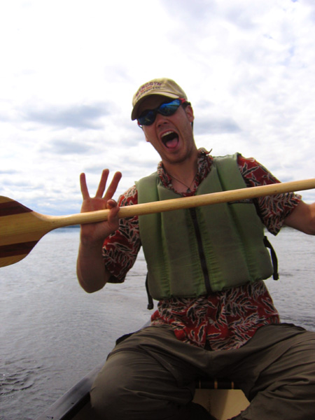 Craig in a canoe, looking like he's darn near lost his mind